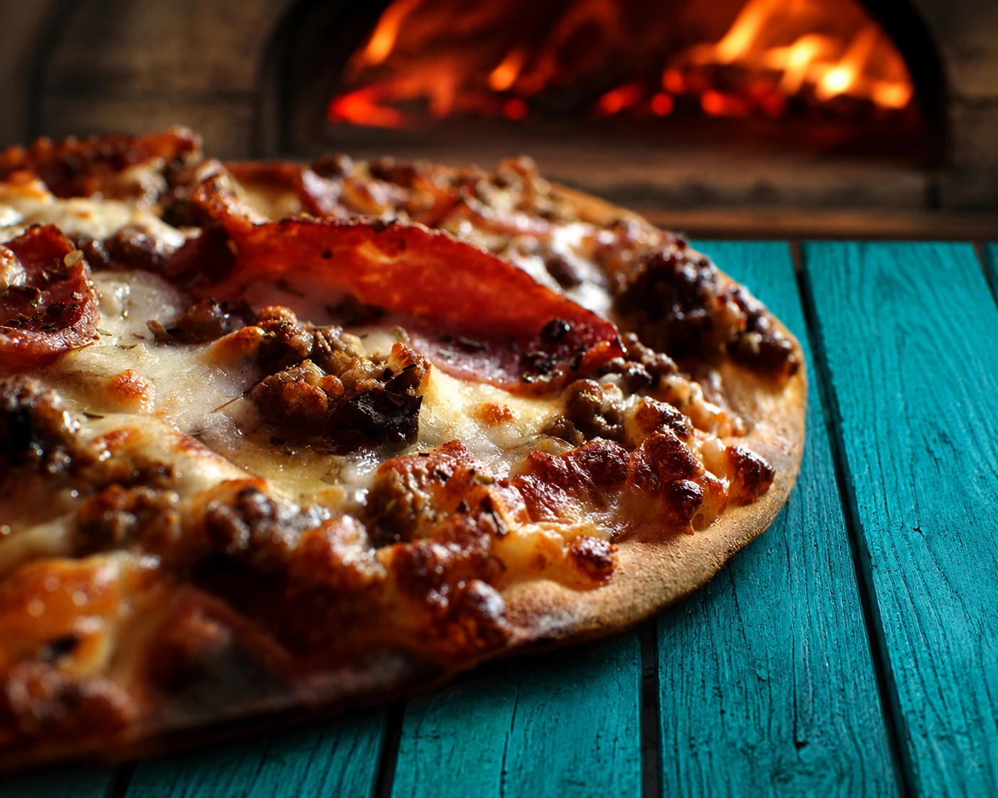 A blistered pizza fresh from the stone oven.